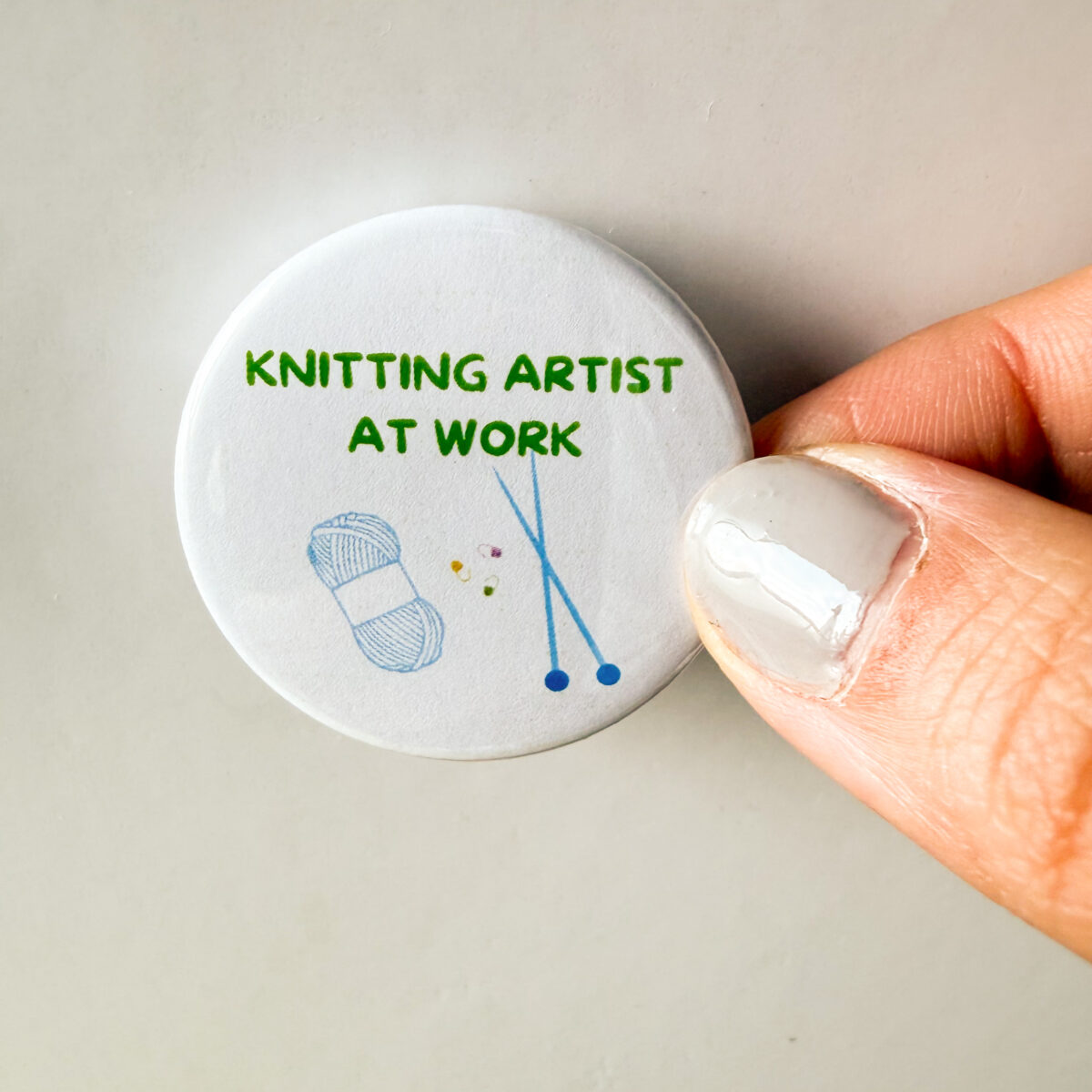 Knitting artist at work - knitting pin badge